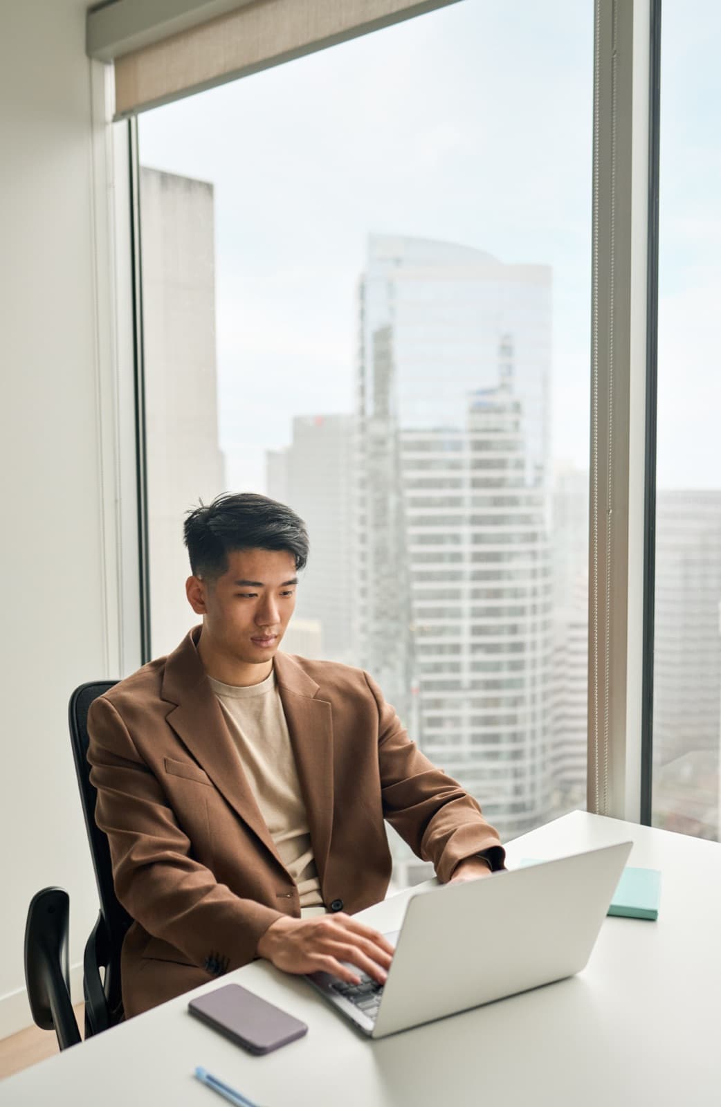 Business professional working on a laptop in a modern office