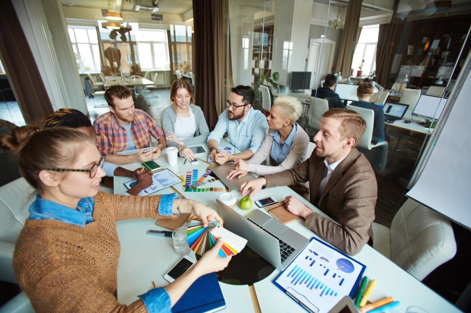 Marketing team collaborating in a meeting at a modern office